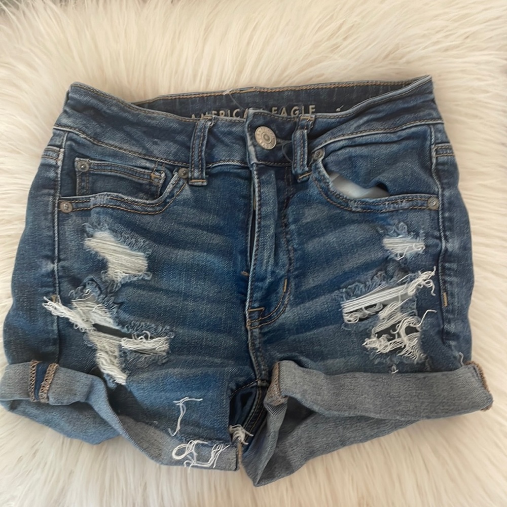 Medium wash ripped American Eagle jean shorts.